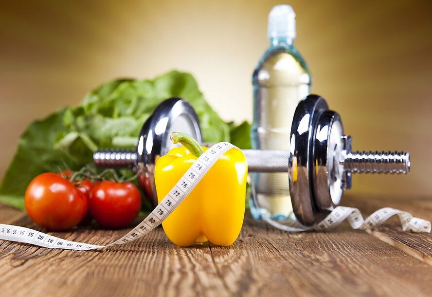 Haltere, vegetais e fita de centímetro